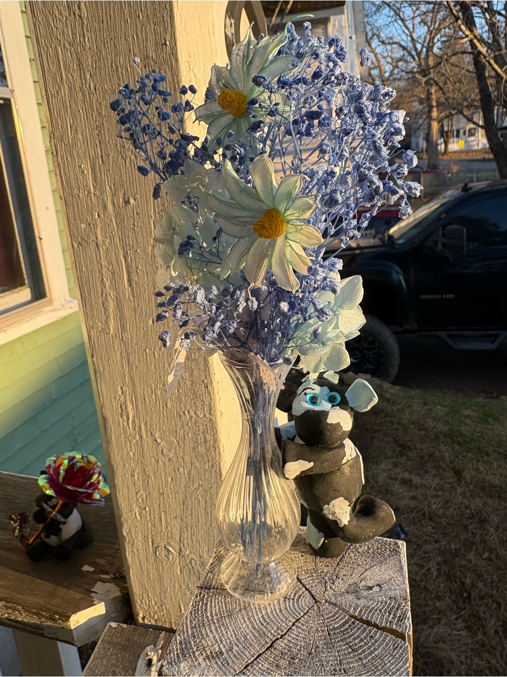 Blue and White Artificial Daisy Bouquet with Cow holding Clear Glass Vase